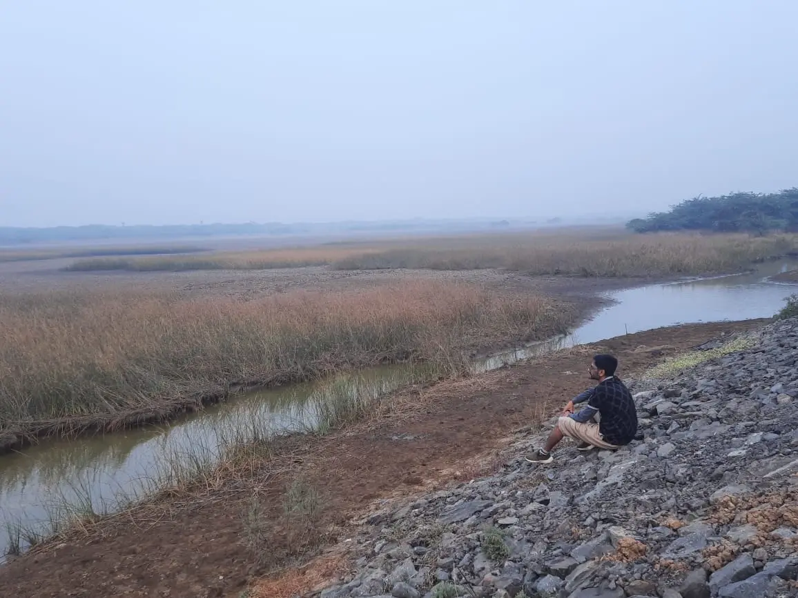 Tapan Patel beside a marsh