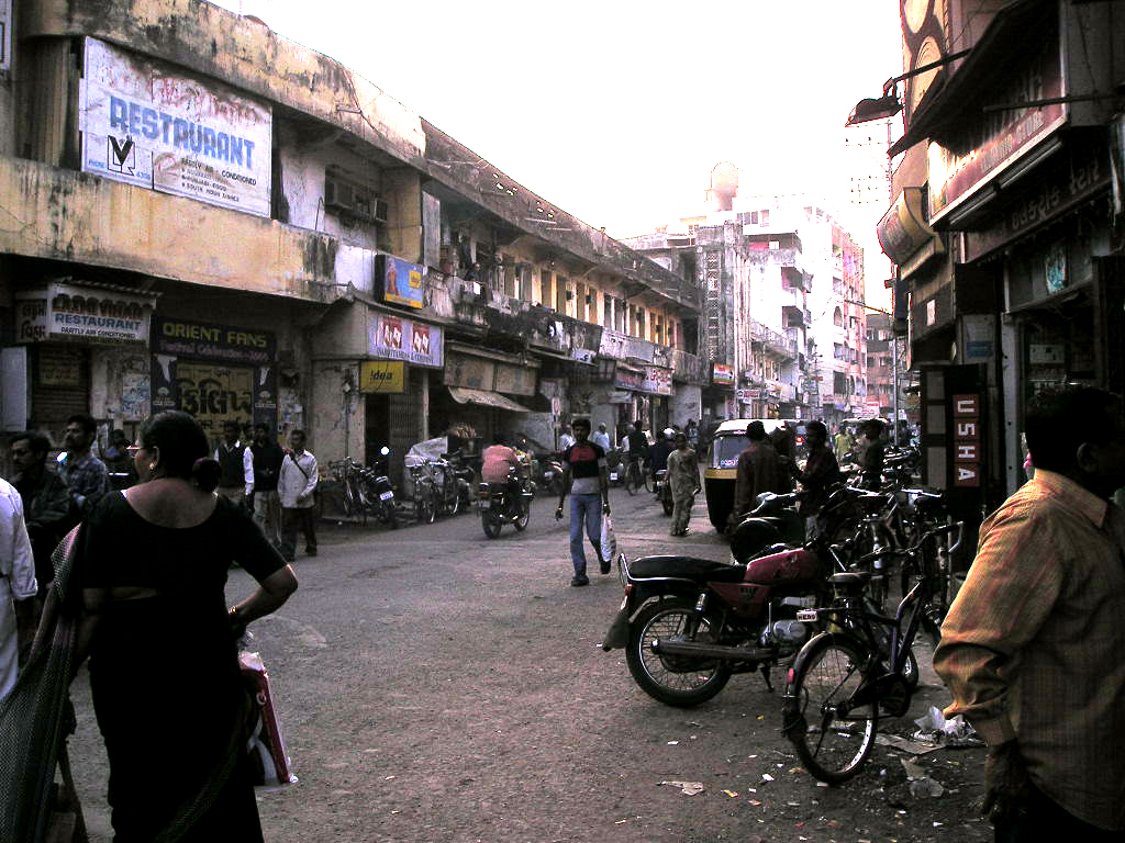 A street in Valsad lined with old shopfronts and a weathered building
