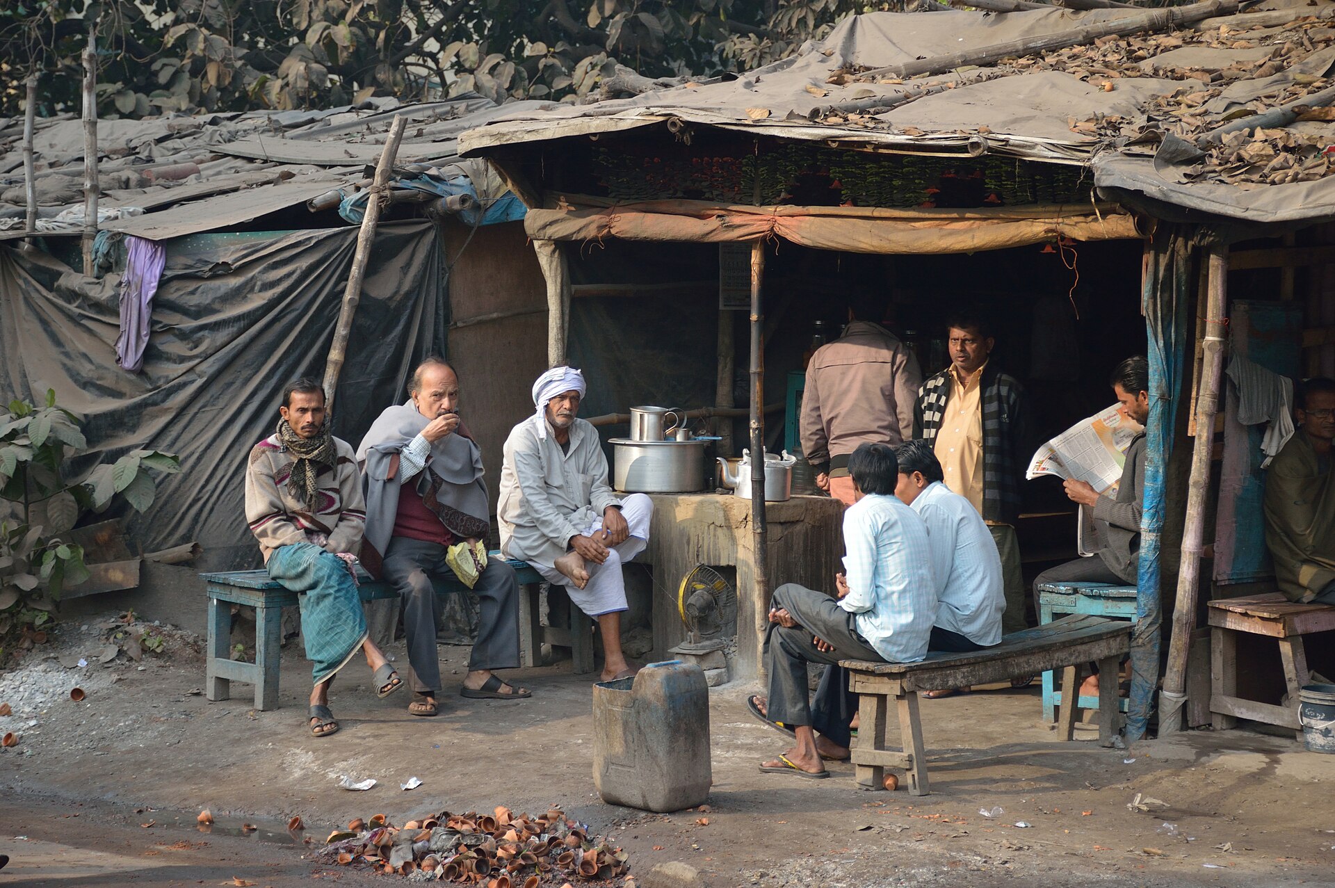 People gathered at a roadside tea stall in Kidderpore, Kolkata